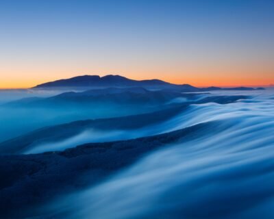 Misty Mountain Sunset Waves Wallpaper