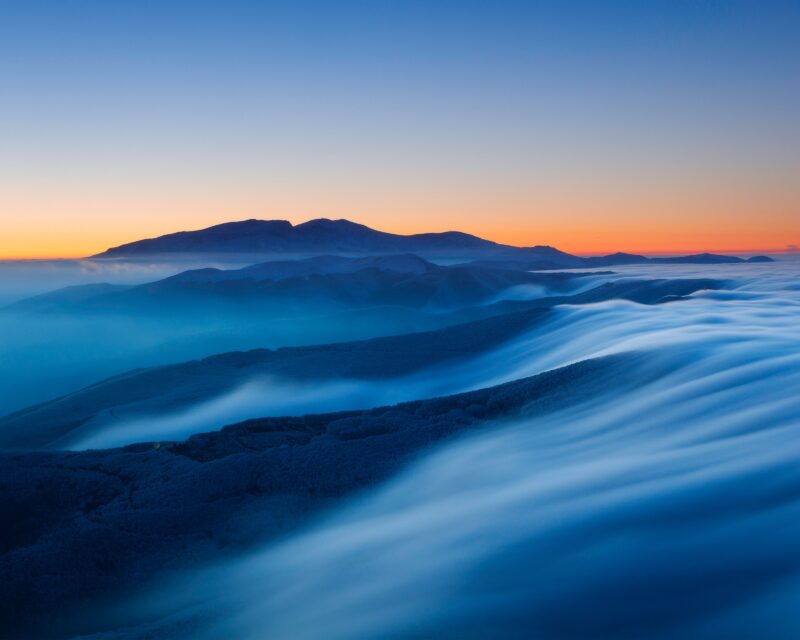 Misty Mountain Sunset Waves Wallpaper