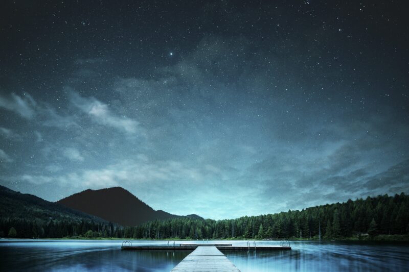 Starlit Jetty Over Tranquil Mountain Lake 4K 5K Wallpaper