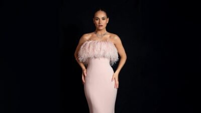 Elegant Pink Feathered Gown on Dark Stage 4K Wallpaper