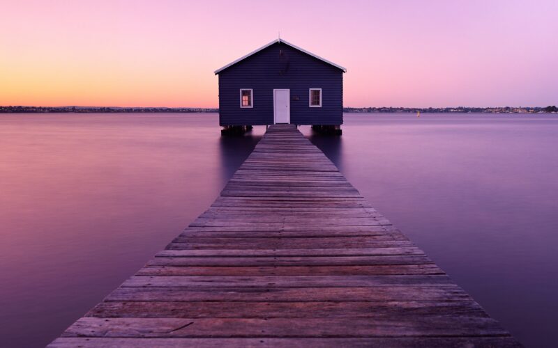 Solitude at Dawn: Riverside Boathouse 4K Wallpaper