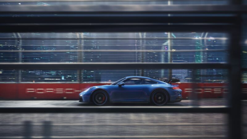 GT3 Blitz: Porsche Screaming Through Urban Shadows 4K Wallpaper